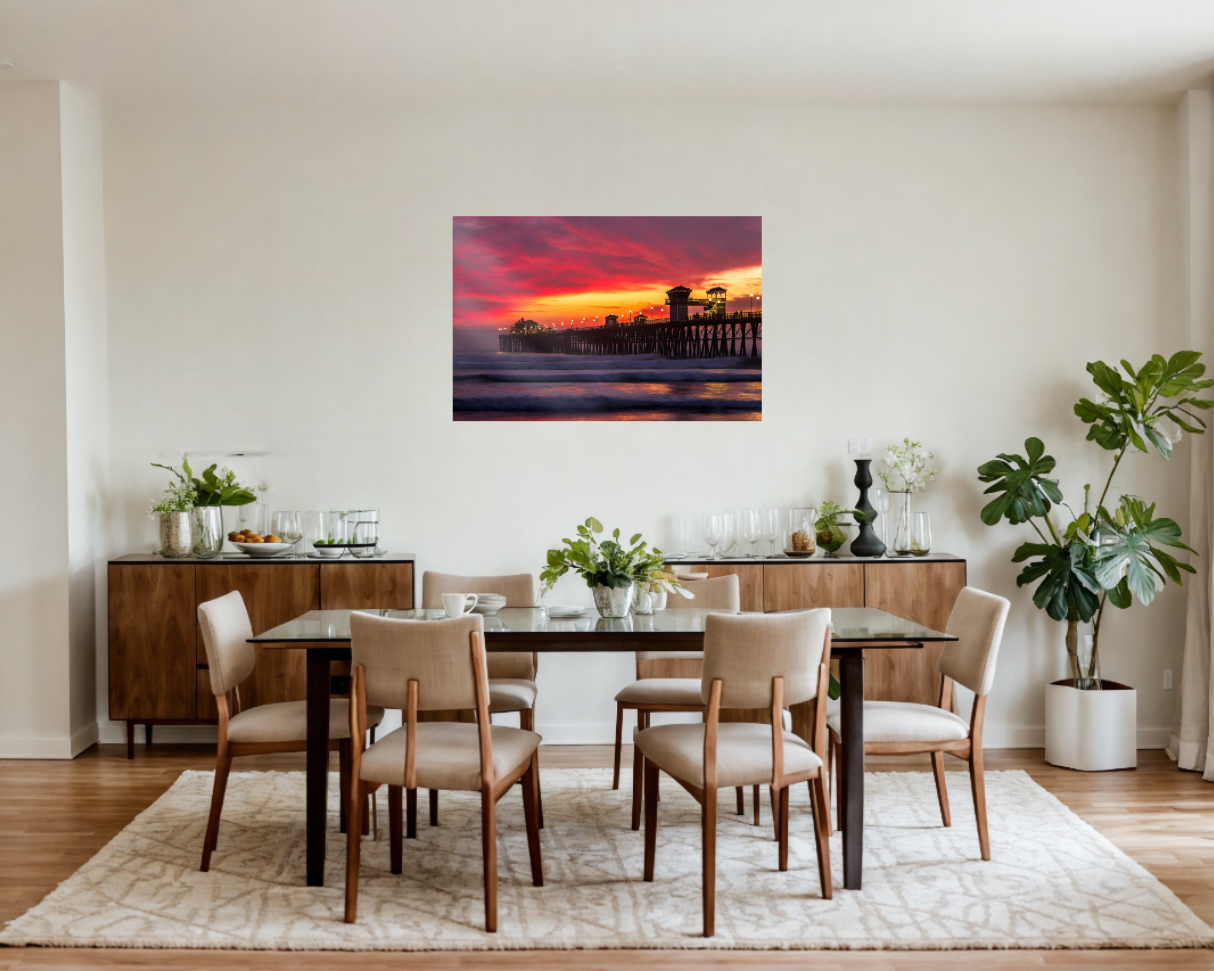 Dining room with a large painting of a sunset over water on the wall.