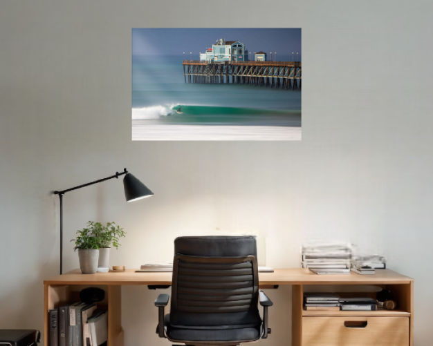 Home office with a desk, chair, and wall art of a lighthouse.